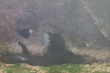 Picture of a natural arch with a freeclimber