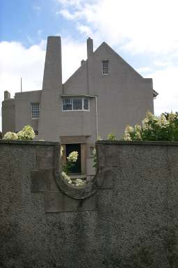 Picture of a view of the entrance through a cut in the garden wall