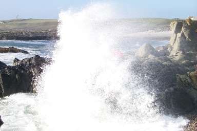 Picture of a wave crashing over rocks