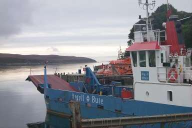Picture of a small car ferry at a calm sound