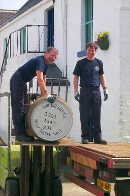 Picture of two workers loading casks on to a lorry