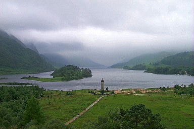 Picture of a view over a loch (Loch Shiel) with a monument (Glenfinnan Monument) at the head of the loch