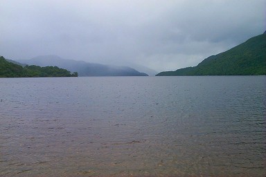 Picture of a view over a loch, rain in the distance