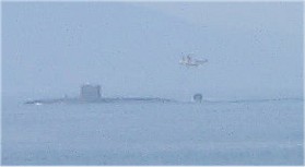 Picture of a submarine and helicopter exercising