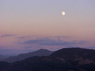 Picture of the moon over some hills