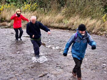 Picture of people crossing a burn