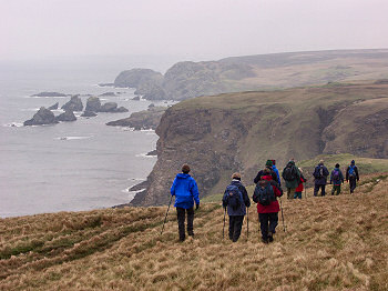 Picture of walkers with impressive cliffs in the background