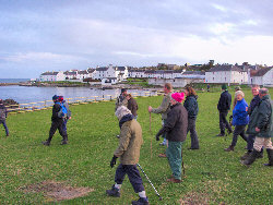 Picture of walkers with Port Charlotte in the background