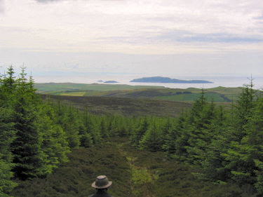 Picture of woods and coastline with Sanda in the distance