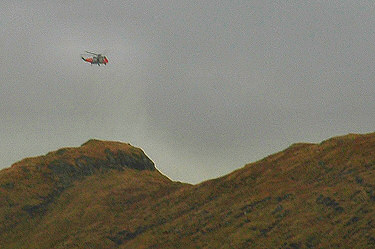 Picture of a helicopter over a mountain ridge