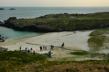 Picture of walkers crossing a small beach