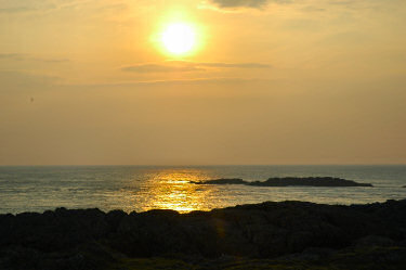 Picture of a sunset over rocks in the sea