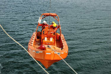Picture of a boat being lowered on a cable