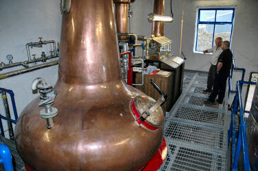 Picture of stills and spirit safe at a distillery