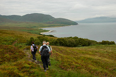 Picture of three walkers over a bay
