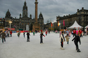 Picture of an ice skating ring with skaters