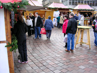 Picture of booths and visitors at the Christmas market