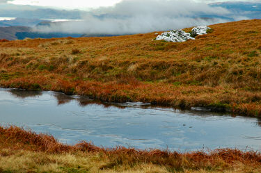 Picture of a lochan with ice on it