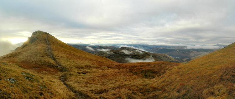 Picture of a panoramic view over a hilly landscape with a sea loch