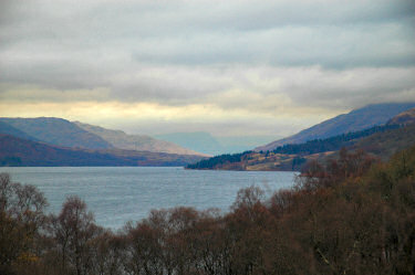 Picture of a view over Loch Katrine under clouds, hills in the background