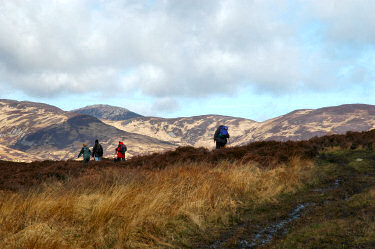 Picture of walkers on a ridge, hills in the background