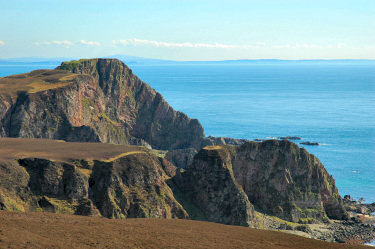 Picture of a view over cliffs towards a dun
