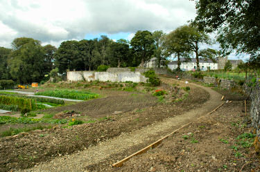 View of a walled garden, old farm buildings in the background