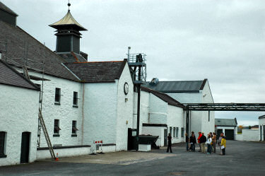 Picture of a group of people standing in the yard of a distillery