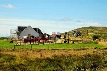 Picture of a playground and a community centre under construction
