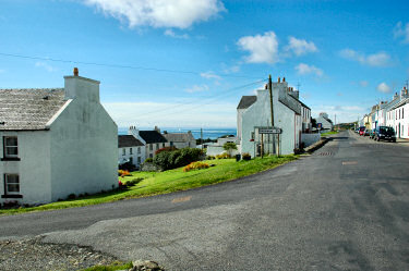 Picture of a road junction in Port Charlotte, sign for the road to Kilchiaran
