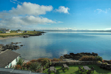 Picture of view over a sunny sea loch with mountains in the distance