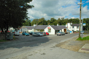 Picture of a square with cars and houses in a small village