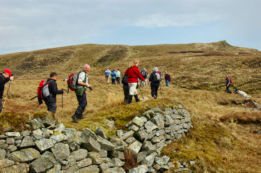 Picture of walkers crossing the remains of a dam