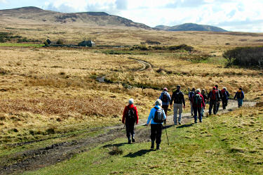 Picture of a group of walkers approaching a disused farm