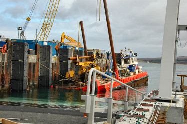 Picture of a partly submerged barge at a pier