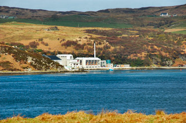 Picture of a view over a sound to a distillery (Caol Ila on Islay)