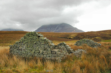 Picture of the ruins of a cottage, hills in the background