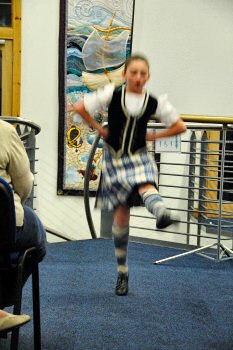 Picture of a dancer of traditional Scottish dance in full flight