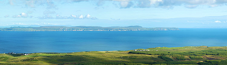 Picture of a view over a sea loch to a peninsula with steep cliffs