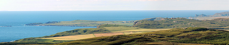 Picture of a view over a bay behind some hills with aerials on the top