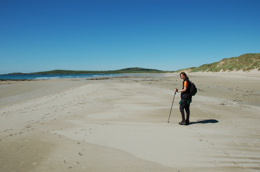 Picture of a woman walking along a beautiful beach