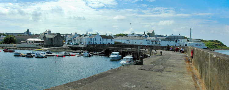 Picture of a panoramic view over a small village harbour next to a distillery