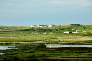 Picture of a small settlement (Carnduncan on Islay) lit up by the sun breaking through