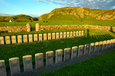 Picture of headstones in a military cemetery in the evening light