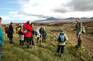 Picture of a head gamekeeper explaining features to walkers