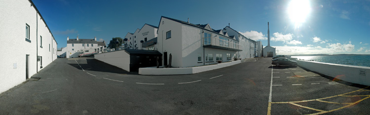 Picture of a panoramic view over a distillery on the shore of a sea loch (Bowmore distillery at Loch Indaal, Isle of Islay)