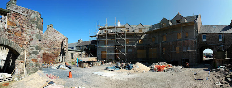 Panorama picture of the back of a building site for a hotel, the second floor is completed