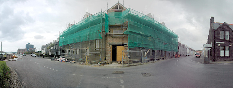 Panorama picture of a building site for a hotel, the roof is nearing completion