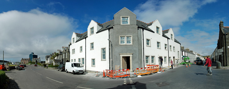 Panorama picture of a building site for a hotel, the windows above the entrance have now been fitted