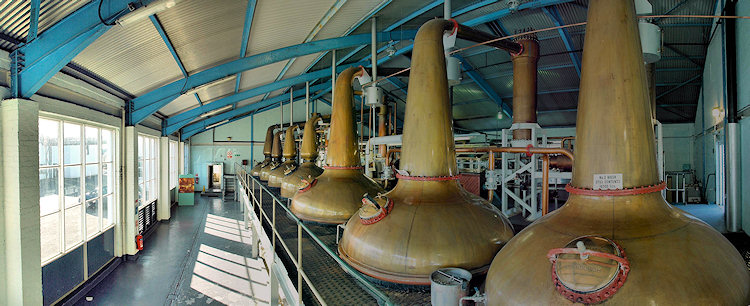 Picture of a panoramic view through the still house of a large distillery (Laphroaig distillery on the Isle of Islay)